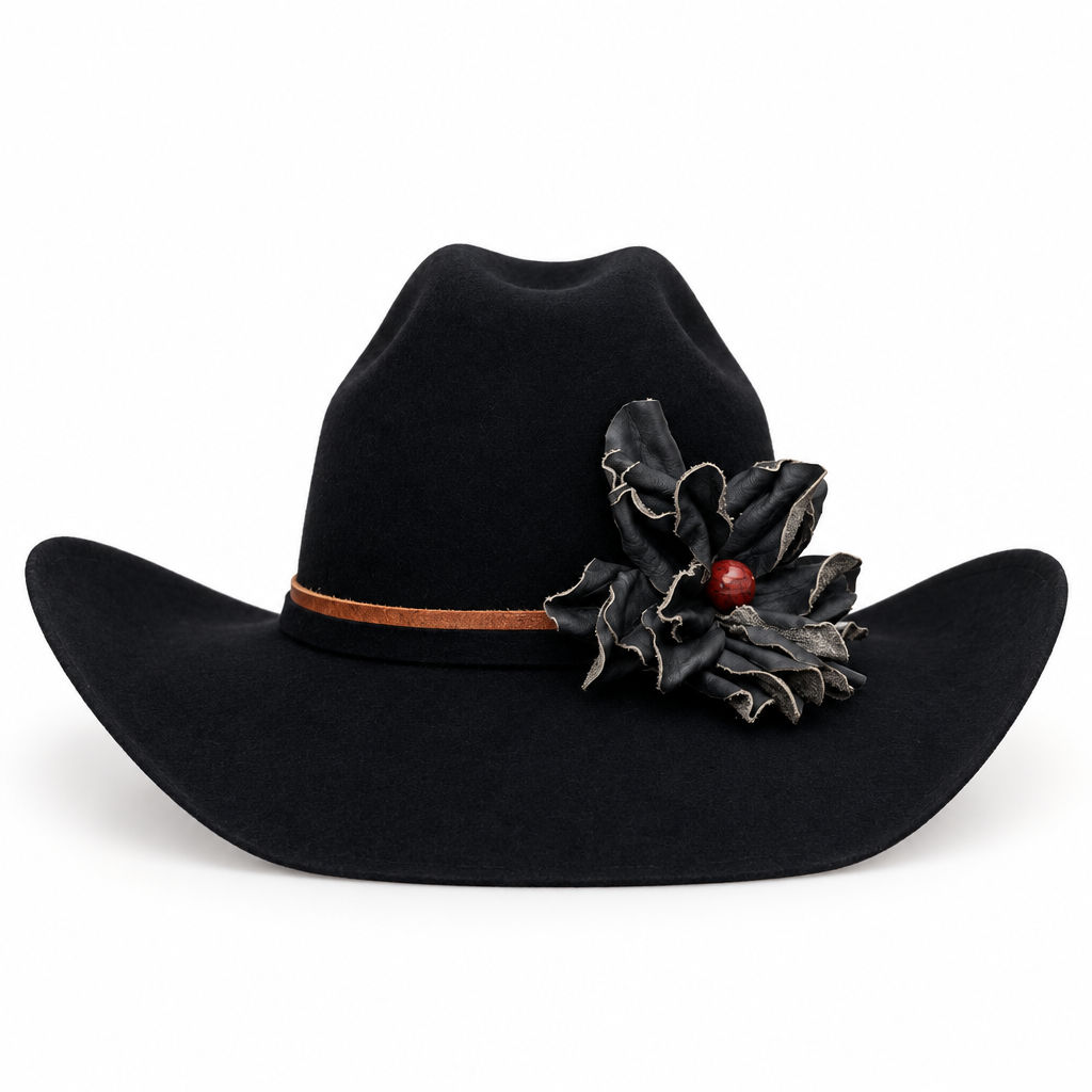 A black felt cowboy hat with a brown hat band and a black leather flower decoration with a small red jasper stone accent, shown against a plain white background.