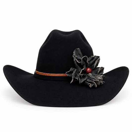 A black felt cowboy hat with a brown hat band and a black leather flower decoration with a small red jasper stone accent, shown against a plain white background.