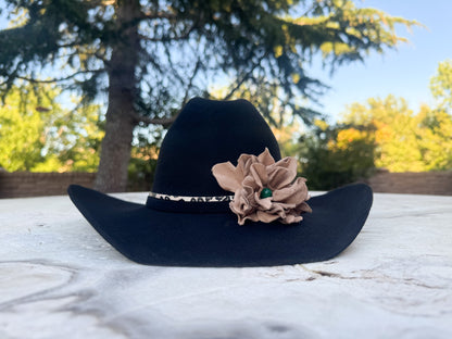 Black Cowgirl Hat w/ Leather Flower & Green Agate Stone Hat Band | Victoria | Westside Cowgirl. The hat is on a marble surface with a blurred natural background