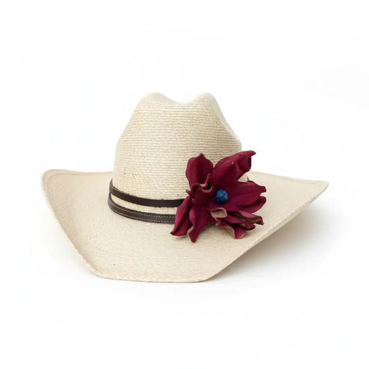 Beige straw cowgirl hat with a red leather flower and black hat band on a white background
