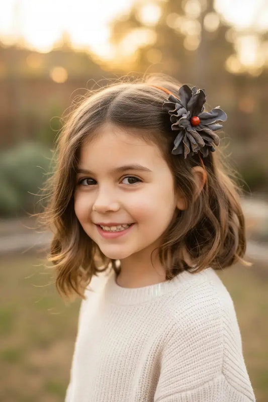 Little girl wearing Black Leather Flower w/ Red Jasper Stone Hair Bow + Headband.