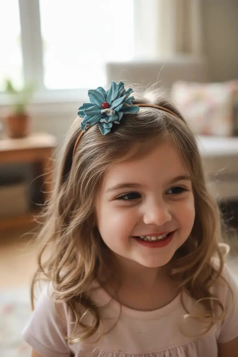 Little girl wearing Turquoise Leather Flower Hair Bow + Headband w/ Red Agate Stone. 