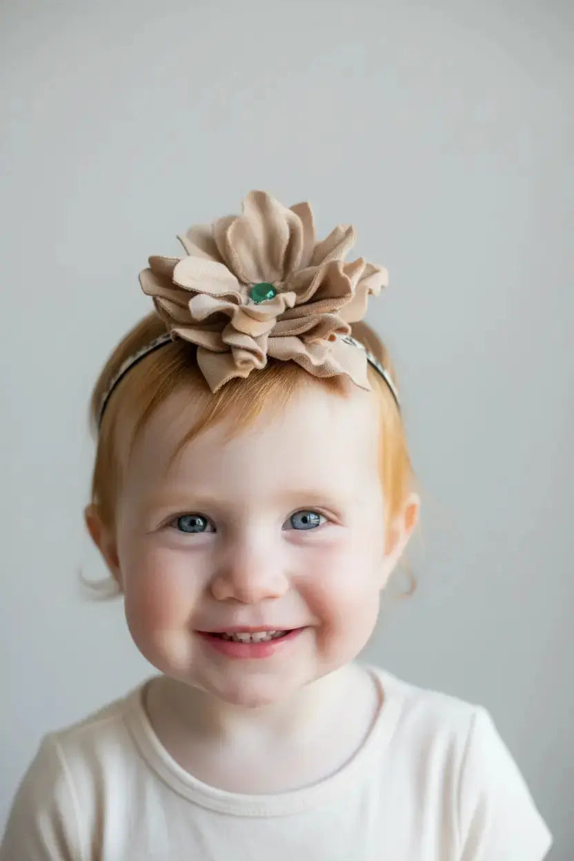 Little girl wearing a leather flower w/ green agate stone hair bow + headband