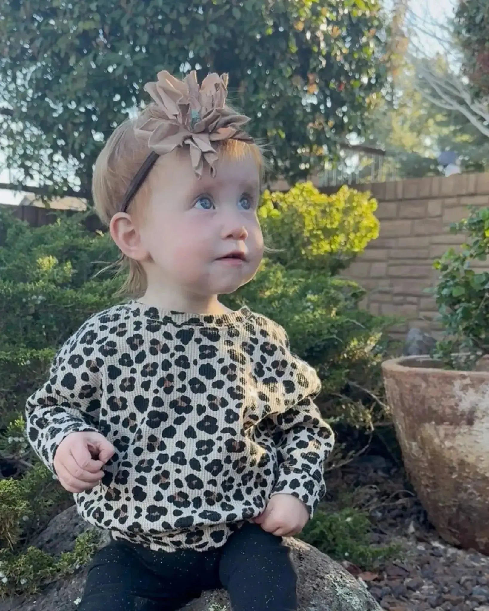 Little girl wearing a leather hair bow + headband w/ a Kingman Turquoise stone in the center. 