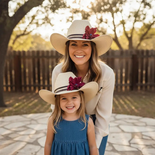 Mom and daughter wearing matching cowgirl hats w/ a red leather flower and blue lapis stone
