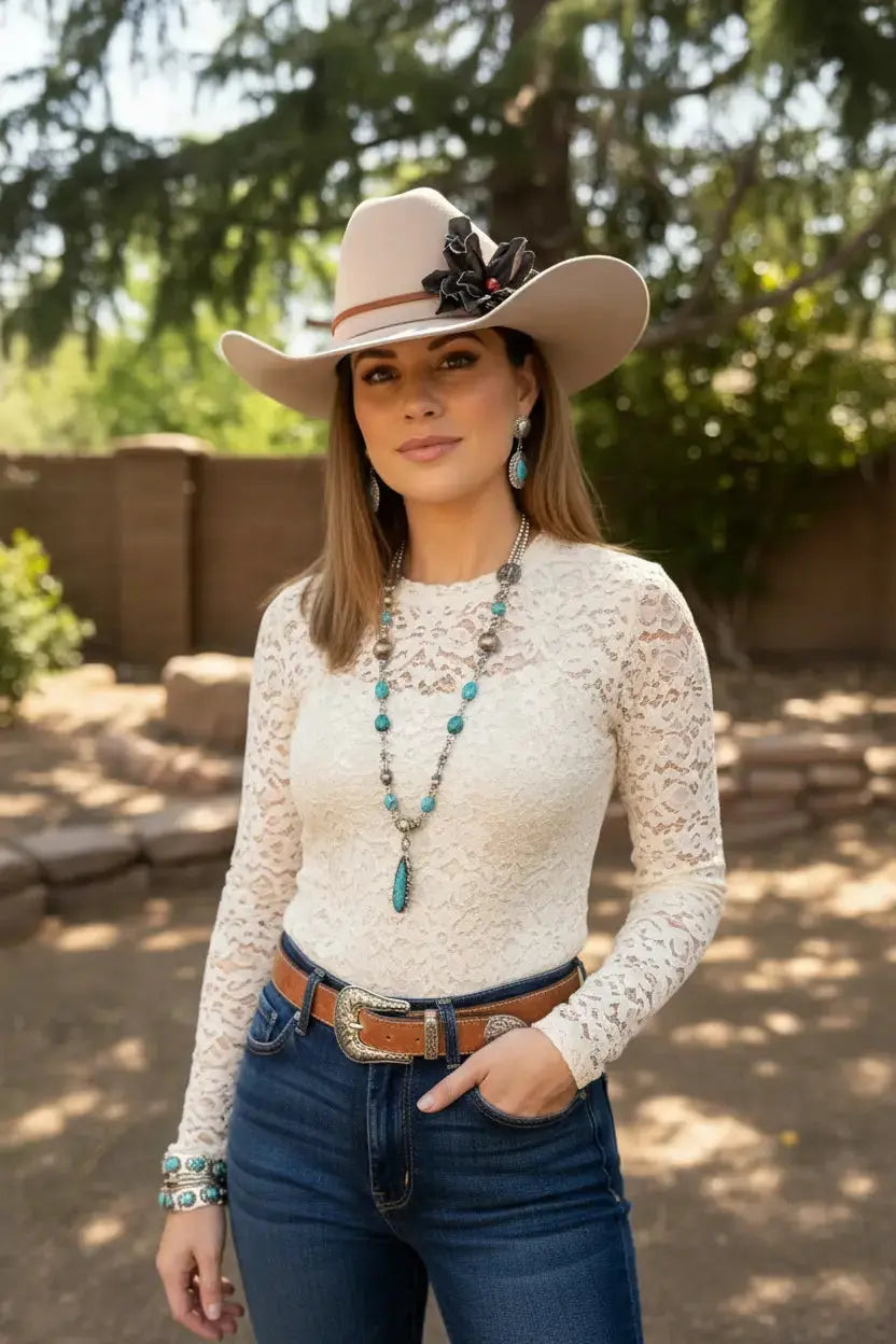 Woman wearing a cowgirl hat w/ a black leather flower & red jasper stone hat band.