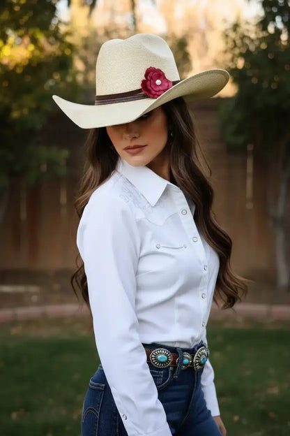 Woman wearing a women's cowgirl hat with a beautiful red leather flower and freshwater pearl hat band on it