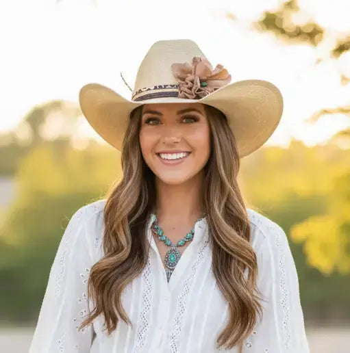 Woman wearing cowgirl hat with a beautiful leather flower leopard lace hat band on it.