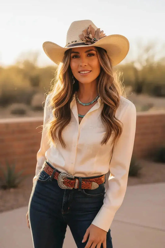Woman wearing cowgirl hat with a beautiful leather flower leopard lace hat band on it