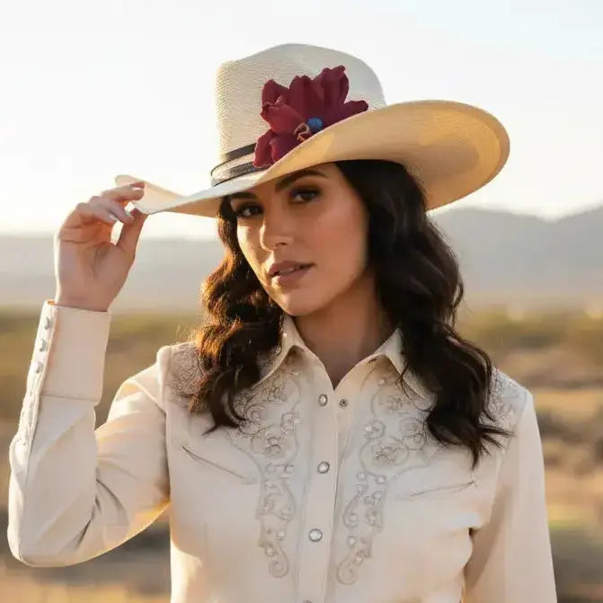 Woman wearing cowgirl hat with a beautiful red leather flower and blue lapis stone hat band on it
