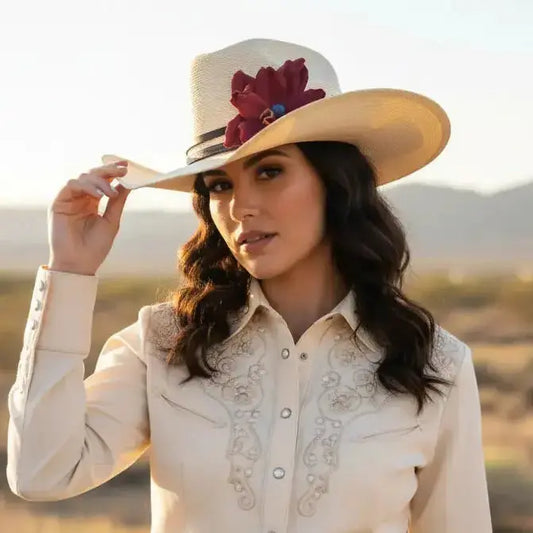 Woman wearing cowgirl hat with a beautiful red leather flower and blue lapis stone hat band on it