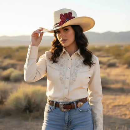 Woman wearing cowgirl hat with a beautiful red leather flower and blue lapis stone hat band on it