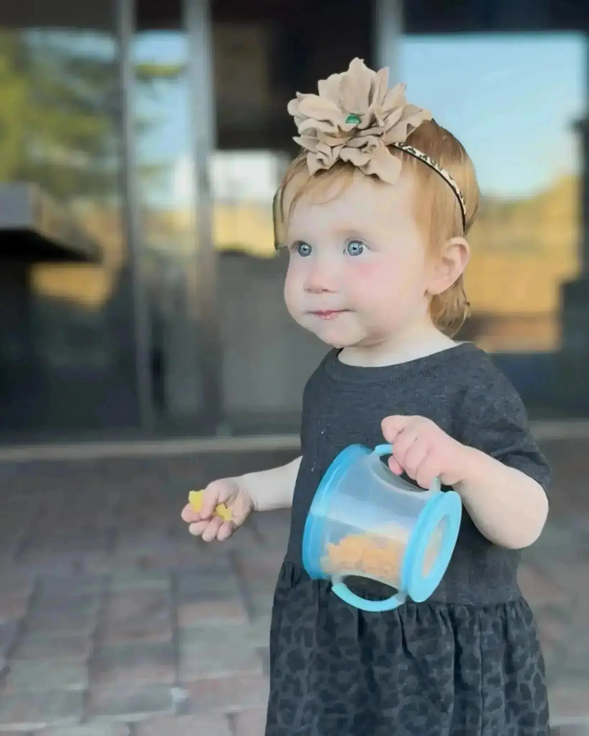 Young girl wearing a Leather Flower w/ Green Agate Stone Hair Bow + Headband. The headband is leopard printed leather lace. Westside Cowgirl
