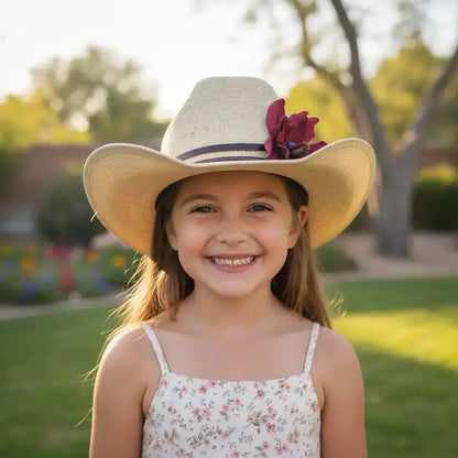 Young girl wearing a cowgirl hat with a red leather flower and blue lapis stone hat band on it.